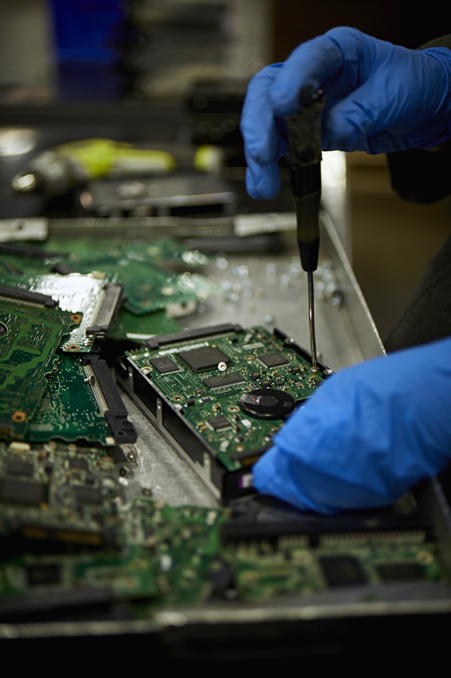 Iron Mountain processing a disk drive for disposal