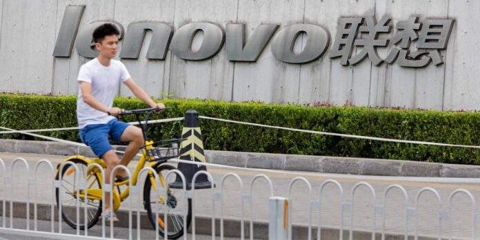 A boy rides by the Lenovo offices on a bicycle.